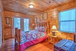 Main Level Bedroom Features a Queen Size Bed, and Access to Covered Deck